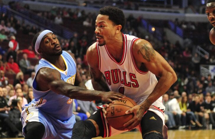Oct 13, 2014; Chicago, IL, USA; Chicago Bulls guard Derrick Rose (1) is defended by Denver Nuggets guard Ty Lawson (3) during the first quarter at the United Center.